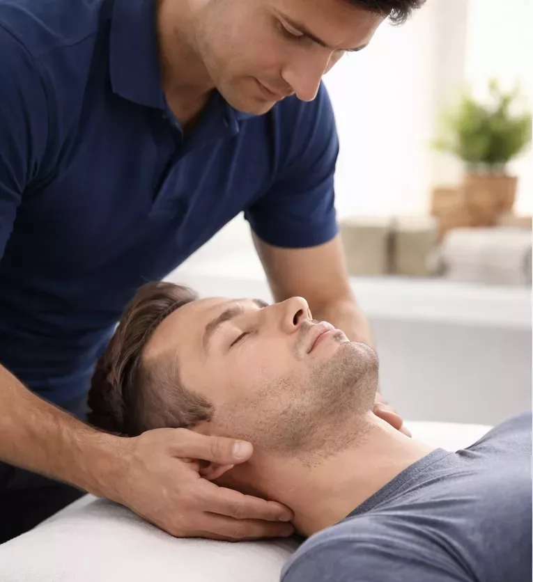 Male receiving osteopathy treatment for shoulder pain and muscle tension relief